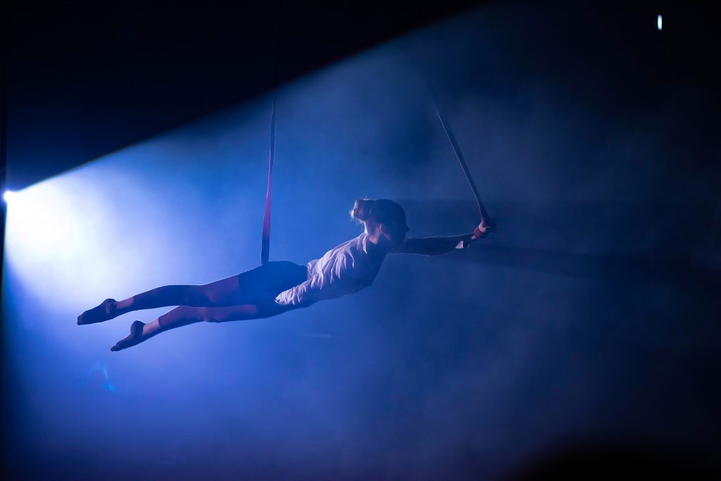 Luftakrobatik des Circus Zappelino im blauen Scheinwerferlicht
